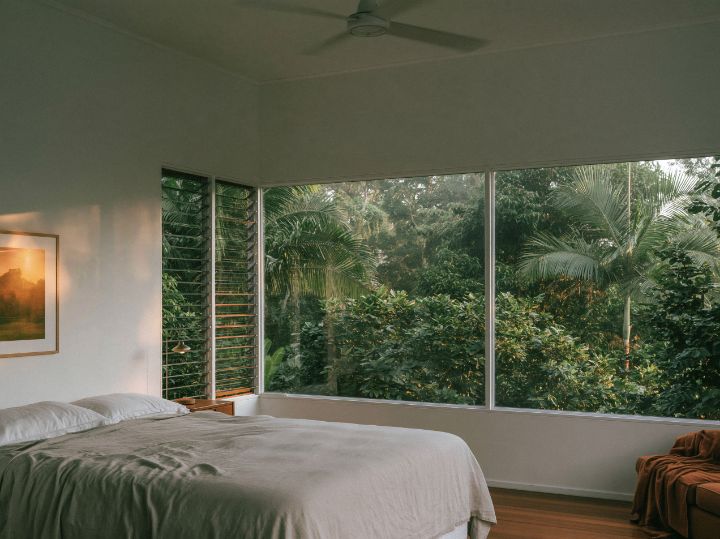 A bedroom with louvres on two sides
