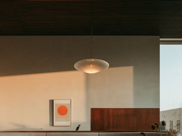 A low timber sideboard and a single pendant
