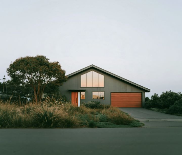 A charcoal gable with a cedar door and a big window in the gable end