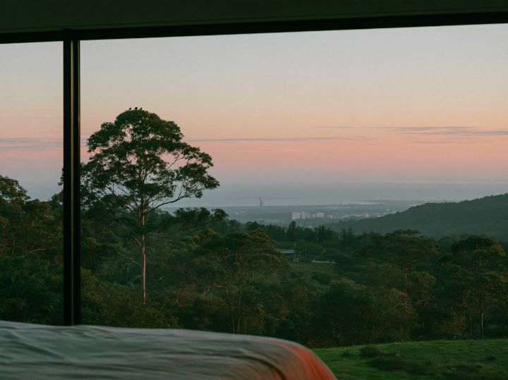 A bedroom on the upper level with the valley below